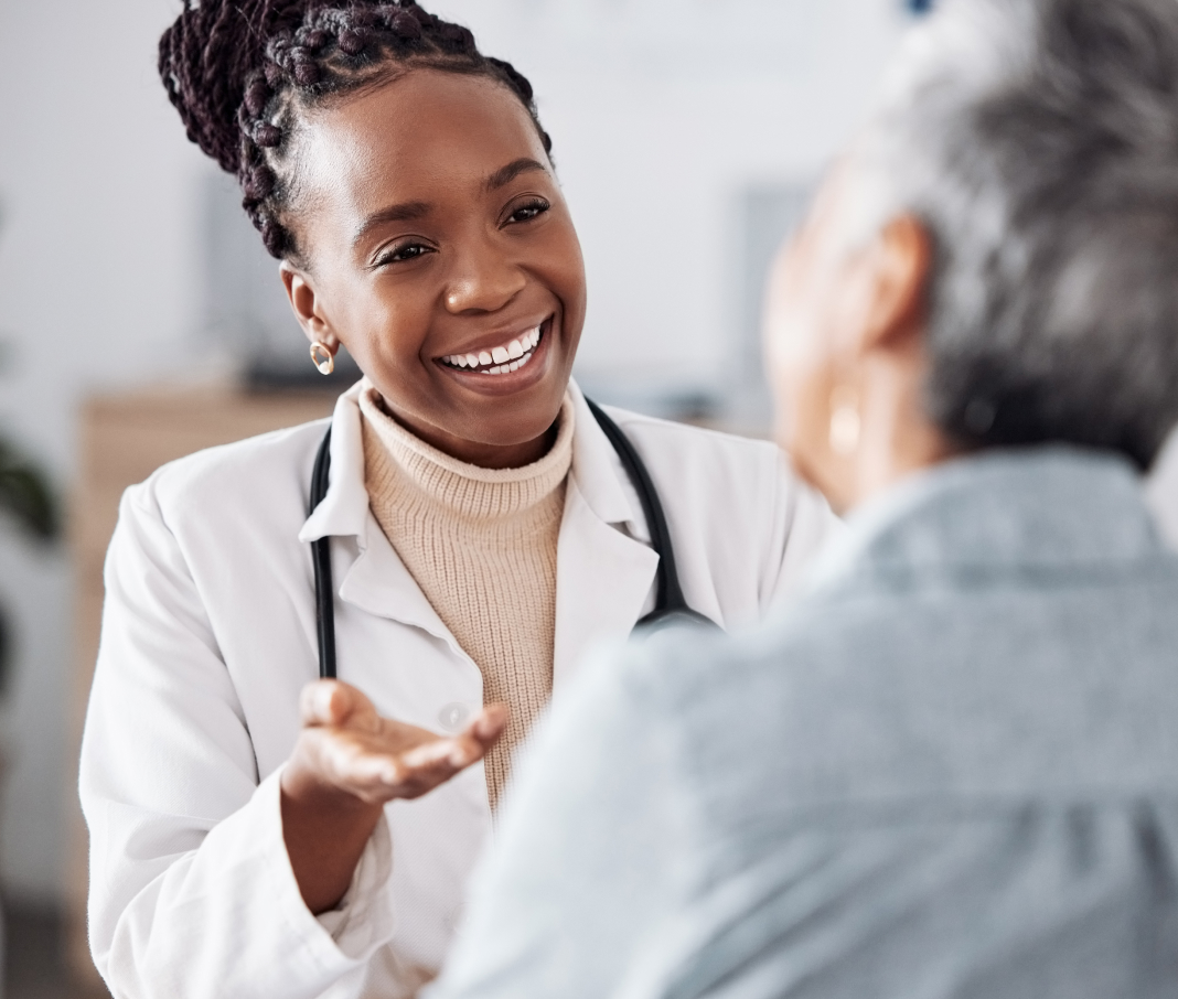 Photo of a doctor speaking with a patient, smiling